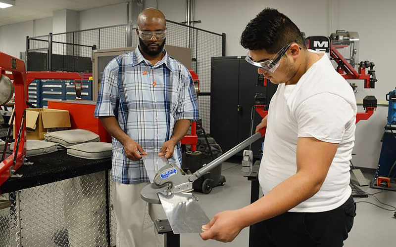 Student using bench shear