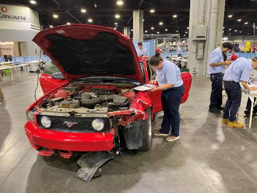 GTCC student Lauren Lewis evaluates a car for the collision damage appraisal category.