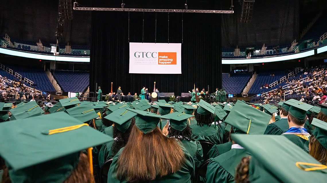 Rear view of students looking toward stage.